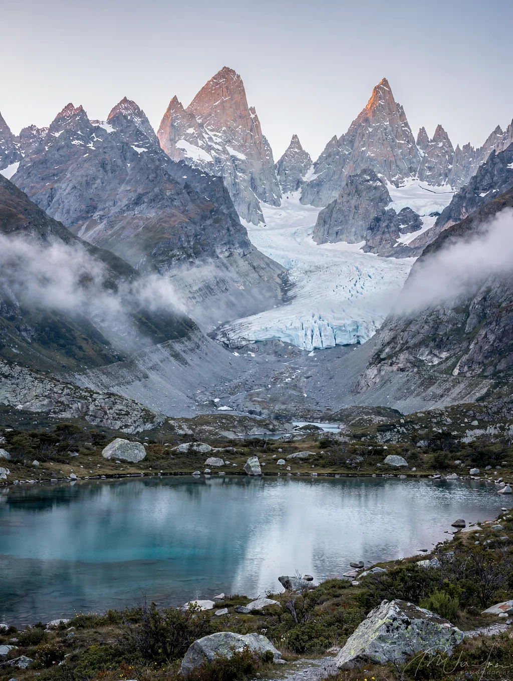 Jagged mountain peaks rising above a frozen glacial lake